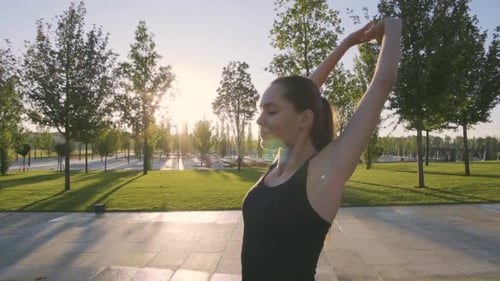 Sports Woman Makes Morning Jog and Physical Exercises In Park