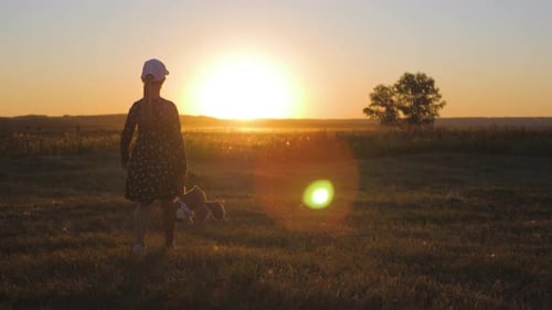 Child Walks with Teddy Bear at Sunset