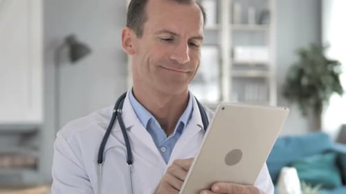 Doctor Using Tablet in Bright Office Setting