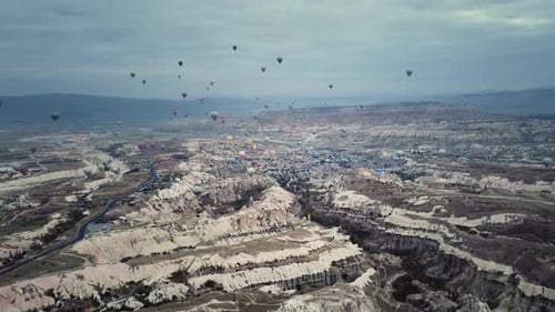 Many Hot Air Balloons Over Picturesque Landscape