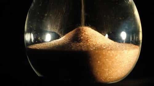 Round Hourglass Flask Where Grains of Sand Fall