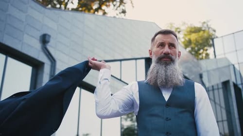 Portrait of Handsome Bearded Mature Man in Suit Outdoors on Modern Building Background During Sunny