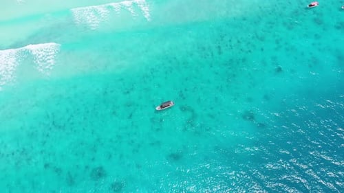 Aerial View of Fishing Boats Swaying on the Waves Off a Paradise Beach Zanzibar