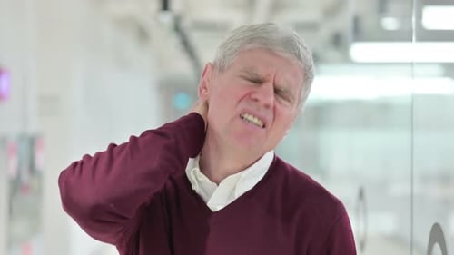 Mature Man Experiencing Neck Pain Close Up