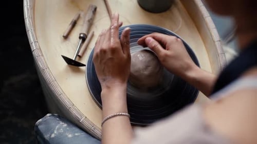 Artist Shaping Clay on Pottery Wheel