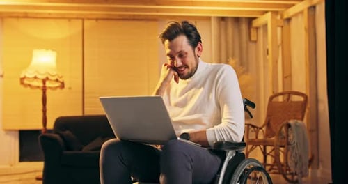 Handicapped Businessman in Wheelchair Using Laptop in Office Corporate Man with Disability