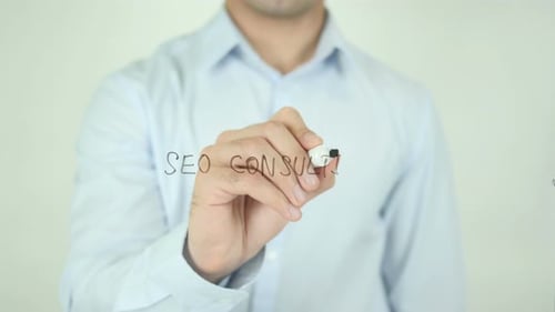Man Writes "SEO CONSULTING" on Glass Surface