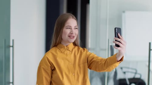 Young Polite Woman Office Manager Video Calling with Foreign Partners Discussing Business Details