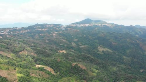 Unique aerial view of tea plantation on hill and tea pickers village on ridge