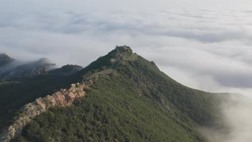 Mountain Peak Above the Clouds Aerial View