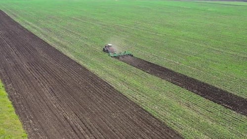 Aerial View Tractor Plows Field