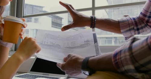 Architects Collaborate on Building Design in Modern Office