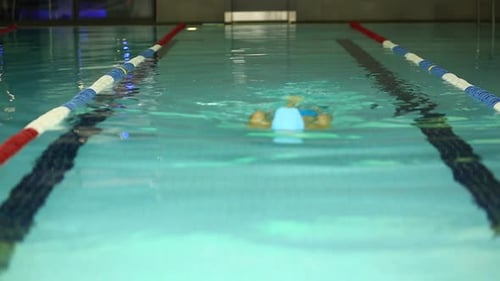 Young Woman Floating In The Pool