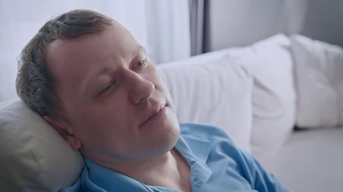 Man Sleeping Peacefully on a Couch During the Day