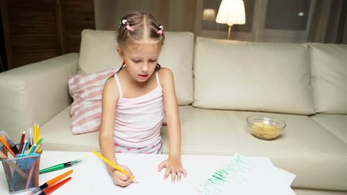Young Girl Drawing at Table in Living Room