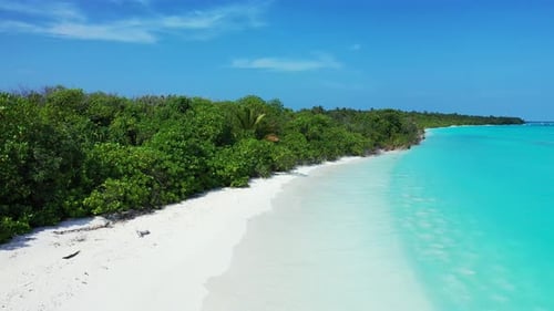 Wide above tourism shot of a white sandy paradise beach and turquoise sea background in 4K