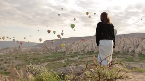 Hot Air Balloons Rise Over Cappadocia Landscape