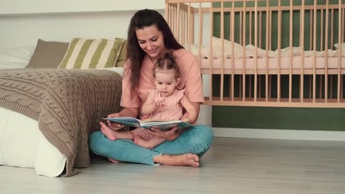 Mother Reading to Baby on Bedroom Floor