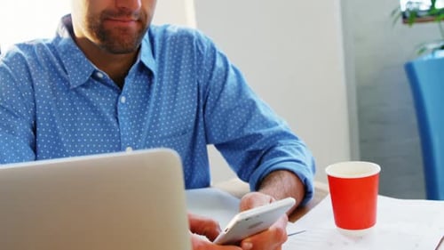 Male business executive using mobile phone