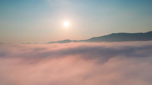 Clouds and Mountains Seen From Above at Sunrise