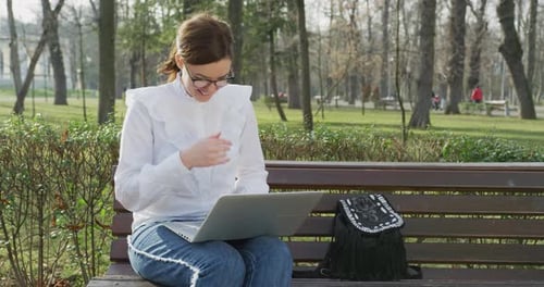 Woman using the laptop in a park