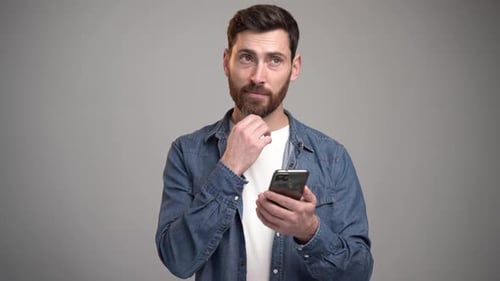 Man Uses Smartphone and Thinks