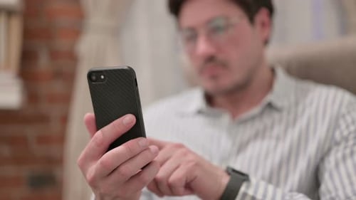 Man Using Cell Phone Indoors, Close Up