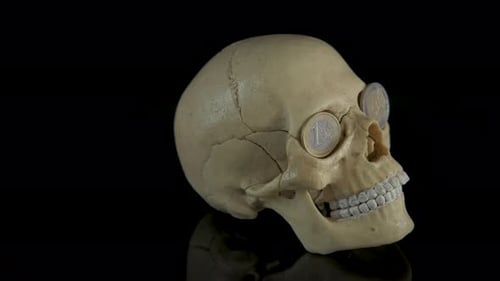 Creepy Skull with Coins in Eye Sockets
