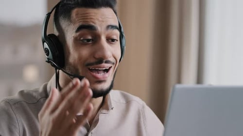 Man with Headset Speaking on a Video Call