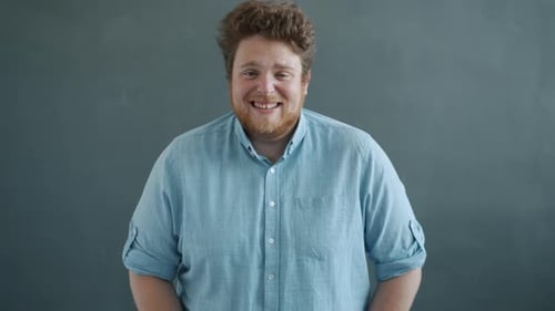 Young Man Smiles then Reacts in Surprise