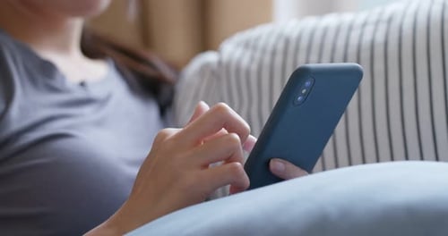 Close up of woman use of smart phone at home