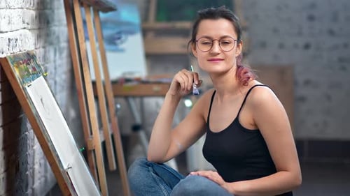 Positive Beautiful Young Painter Woman Posing at Art Studio During Working Medium Shot