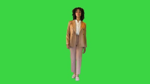 Young Curly African Girl Walking on a Green Screen Chroma Key