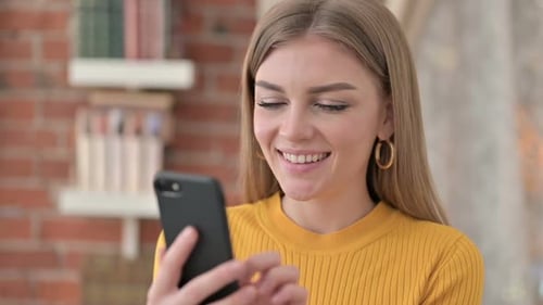 Smiling Woman Using Mobile Phone Close Up