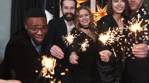Friends Celebrating with Sparklers at Nighttime Party