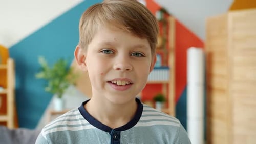 Blond Boy Speaking Indoors, Close Up Portrait