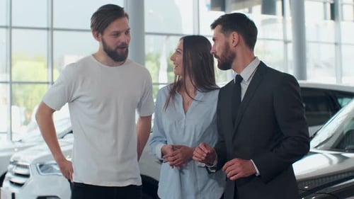 Couple Buying a New Car at Dealership