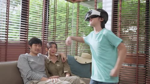 Child Using VR Headset at Home with Family