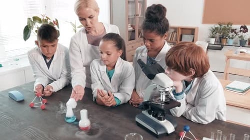 Students Learn Science with Teacher in Classroom