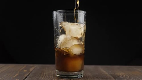 Refreshing Soda Pouring Over Ice Cubes