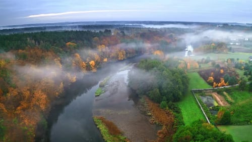 Foggy river in autumn at sunrise, aerial view