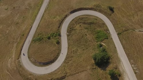 Aerial view of a man driving a motorbike on a mountain road