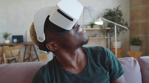 Young Man Wearing VR Headset Smiling