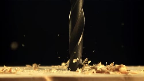 Drill Bit Drilling Into Wood in Close Up