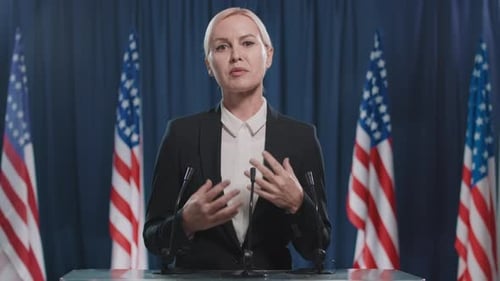 Woman Giving a Speech at Podium With US Flags