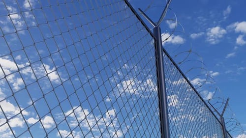 Jail Barbed Wire Fence Against Blue Sky and View Iron Fence of Prison Boundary