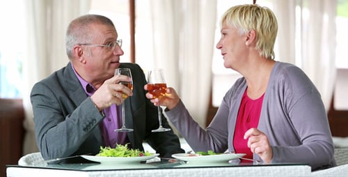 Mature Couple Enjoying Lunch and Wine Together