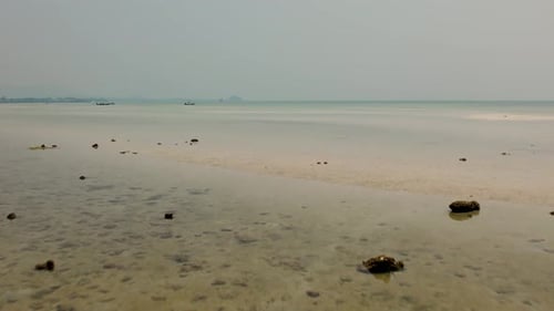 Flying low over the sandbank of tropical turquoise water beach. Aerial