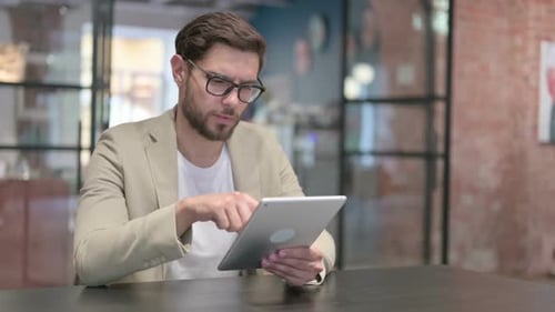 Attractive Young Man Using Tablet