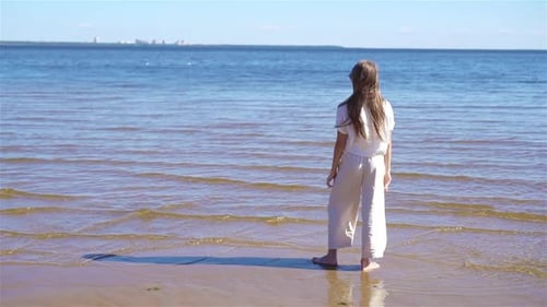 Adorable Little Girl at Beach During Summer Vacation